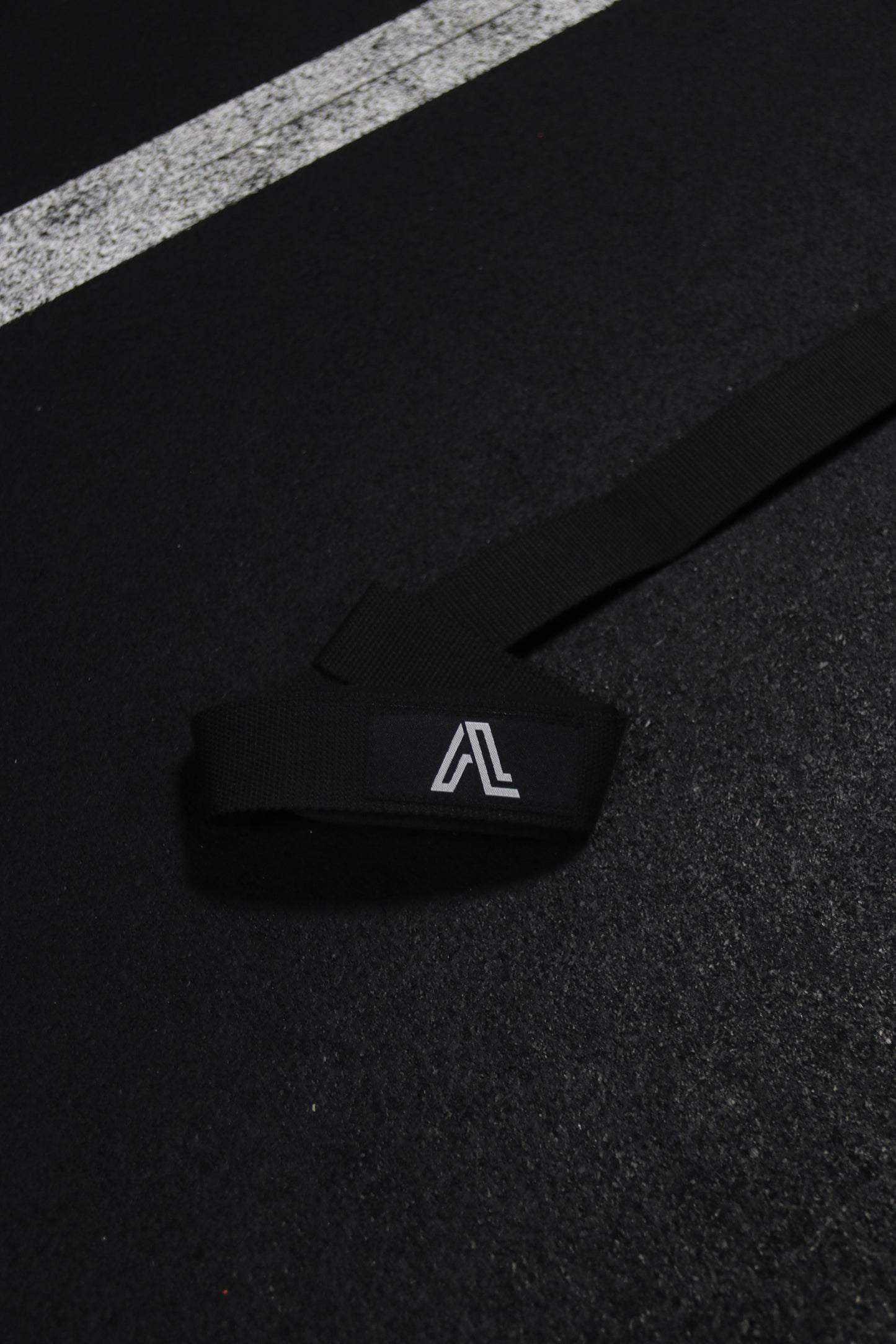 Black strap with a logo on a black surface