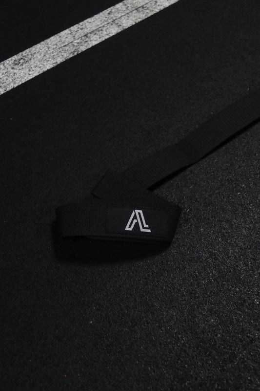 Black strap with a logo on a black surface