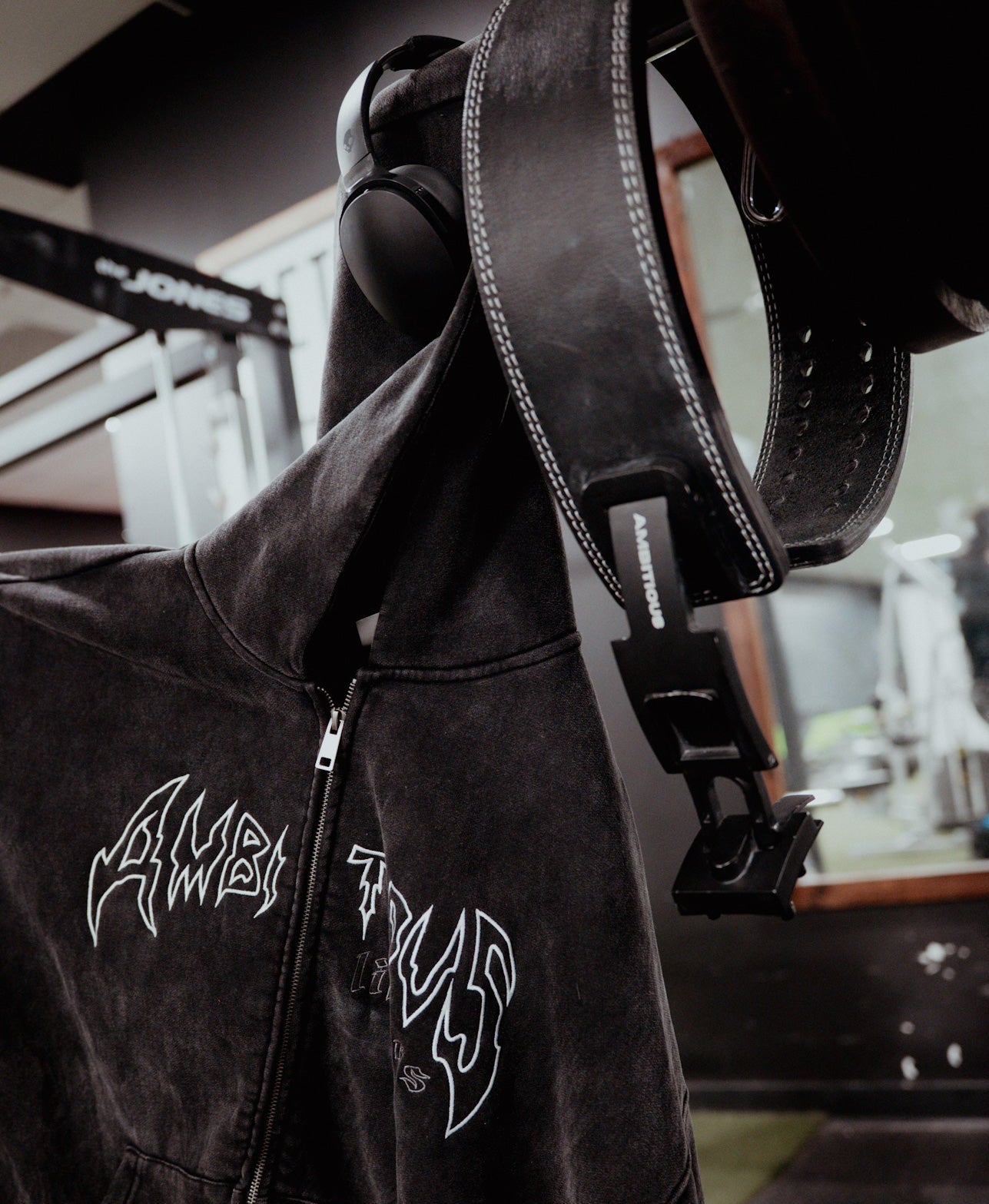 Black jacket with white logos on a blurred background